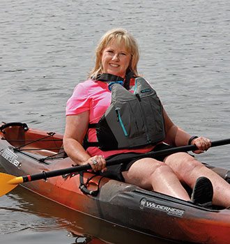 Shoandra Fagg kayaking on a lake.